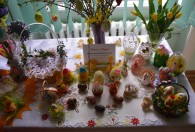 Zdjęcie przedstawia kurczaczki, pisanki oraz tulipany w wazonie